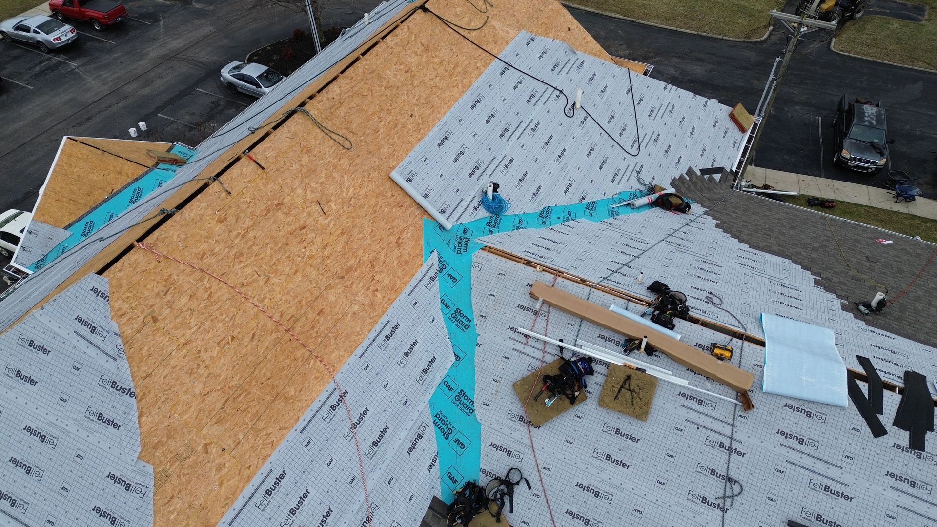 An aerial view of a roof being installed on a house.