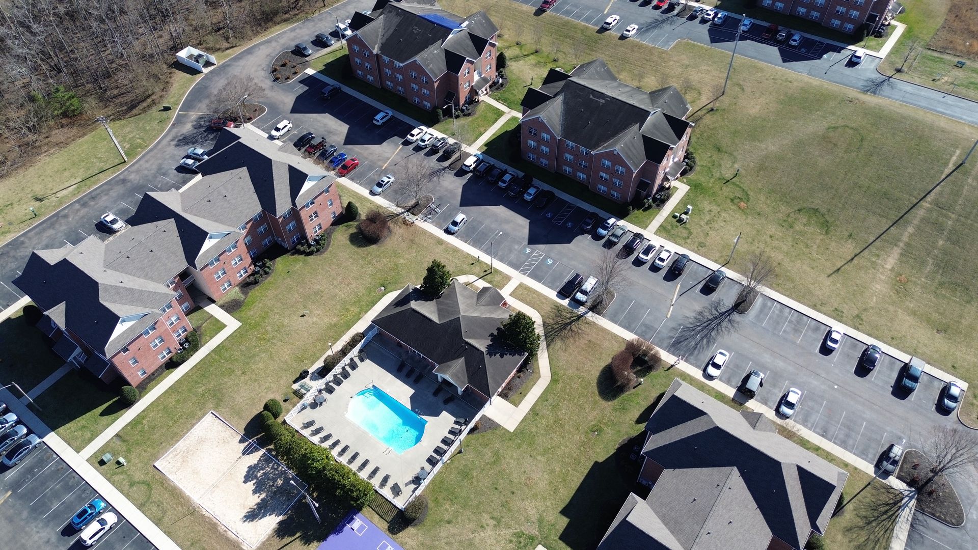 An aerial view of a residential area with a swimming pool