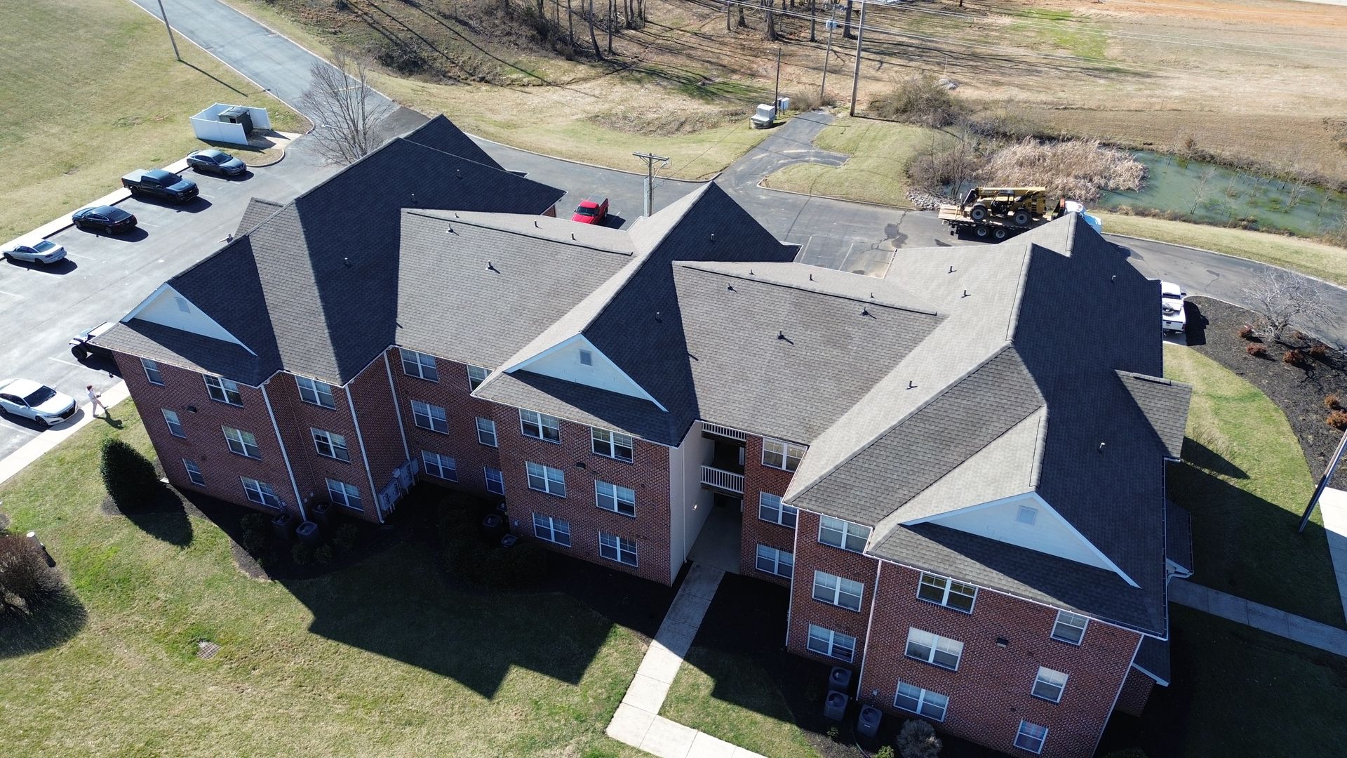 An aerial view of a large brick apartment building