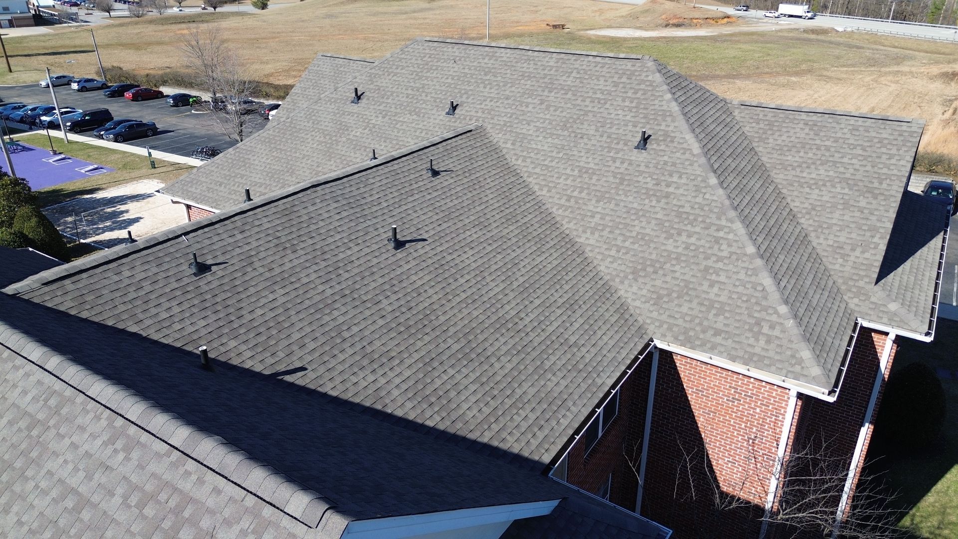 An aerial view of a house with a gray roof.