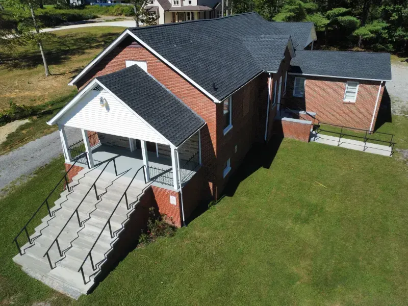 An aerial view of a brick building with a handicap ramp