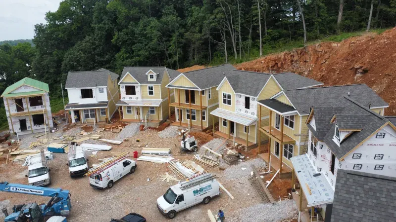 An aerial view of a row of houses under construction.