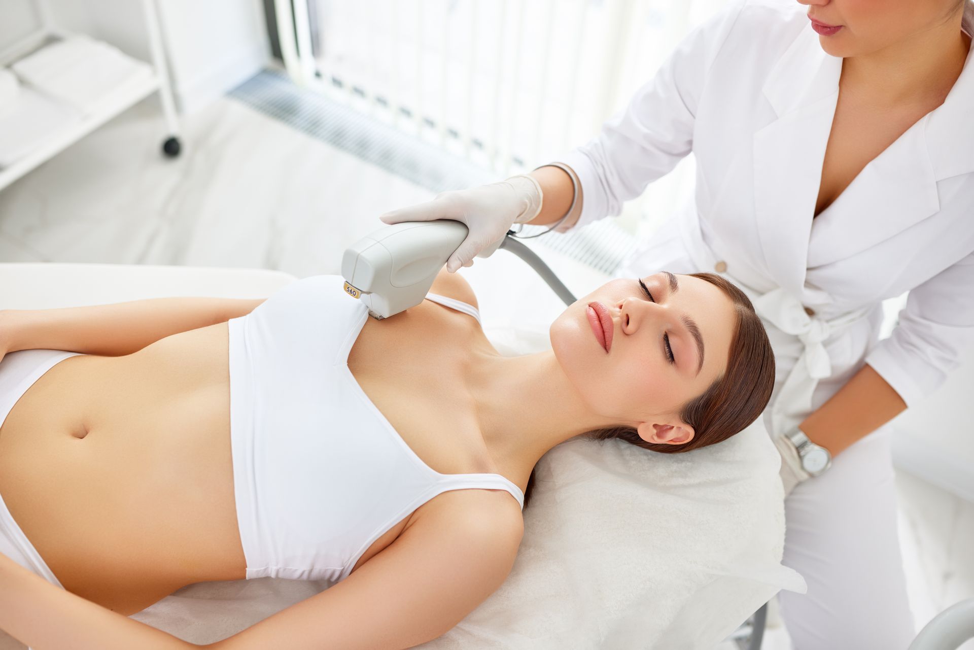 Woman receiving laser treatment on her chest.
