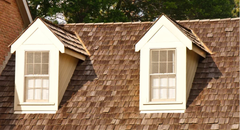 An inviting view of a wooden shaker roof showcasing two dormer windows, adding charm and character to the architectural design.