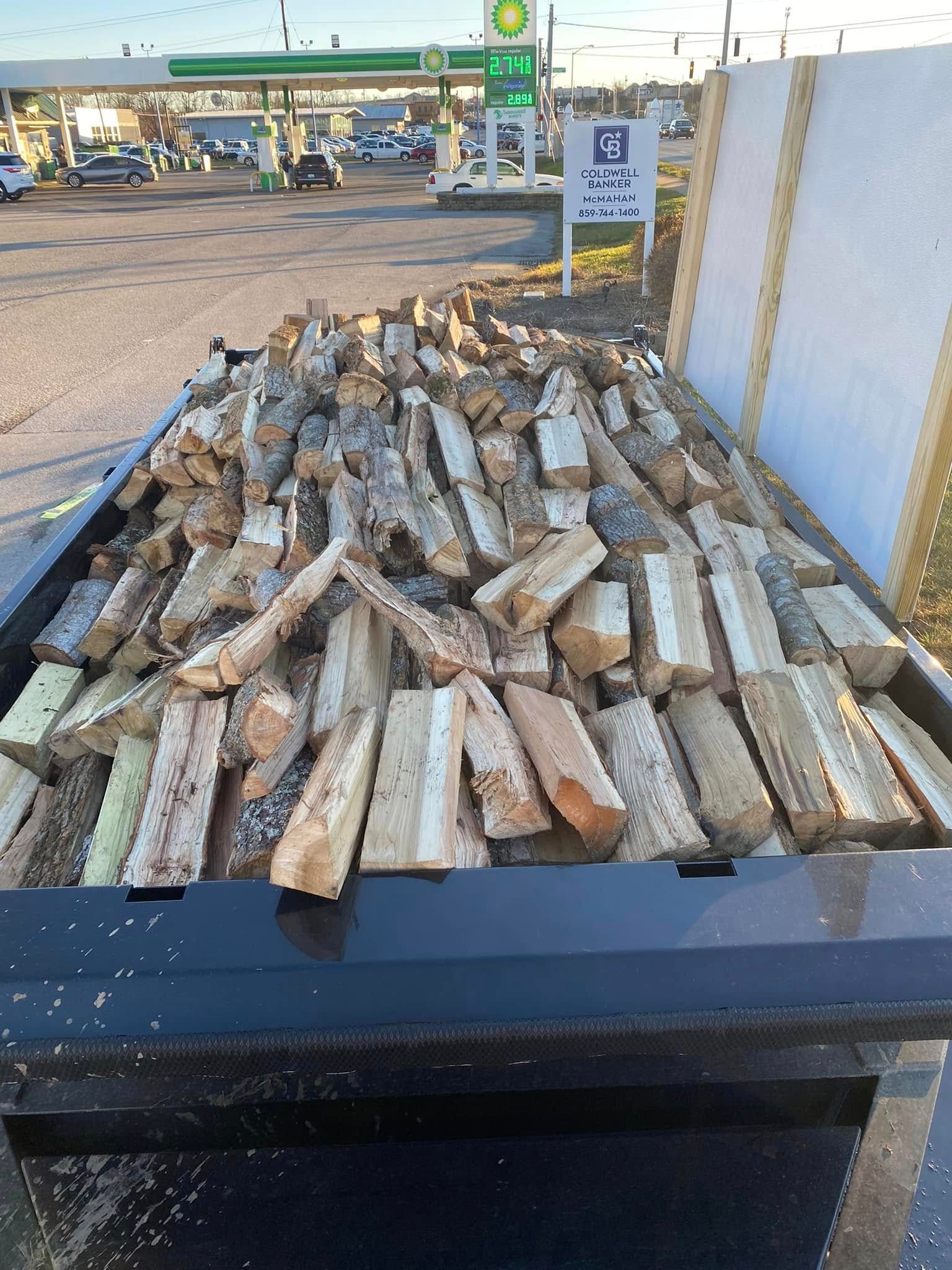 A pile of wood is sitting in the back of a dumpster.