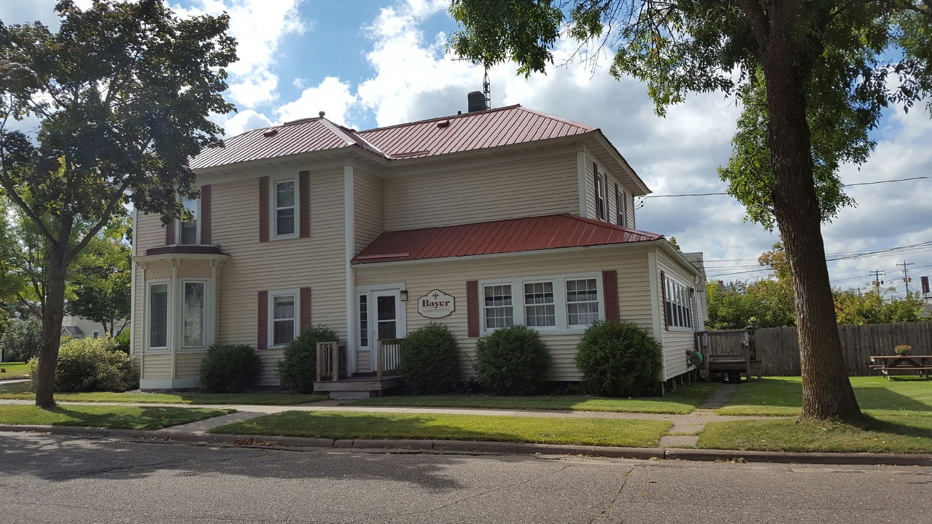 A house with a red roof and a lot of windows