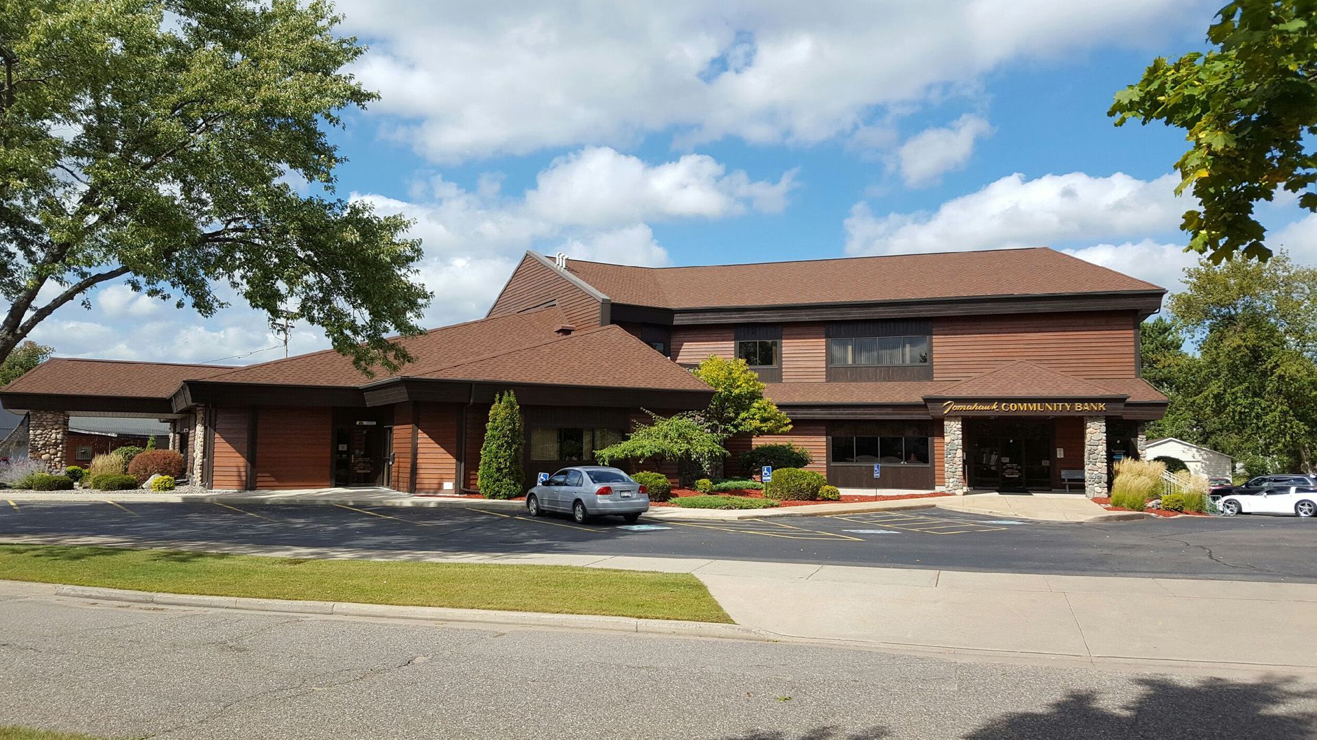 A large brick building with a car parked in front of it.