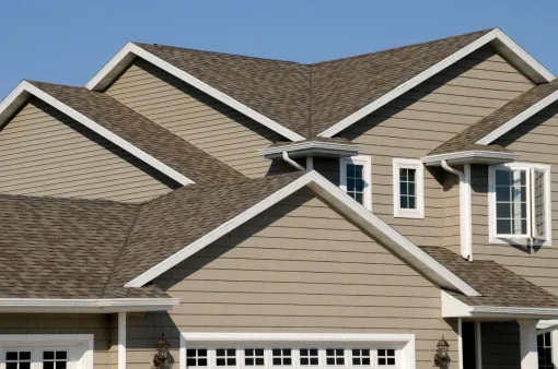 A large house with a brown roof and white trim