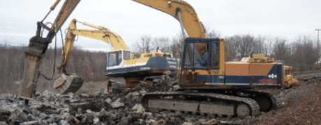 Backhoe Excavating Building Debris — Construction And Excavation Services in Harrisburg, PA