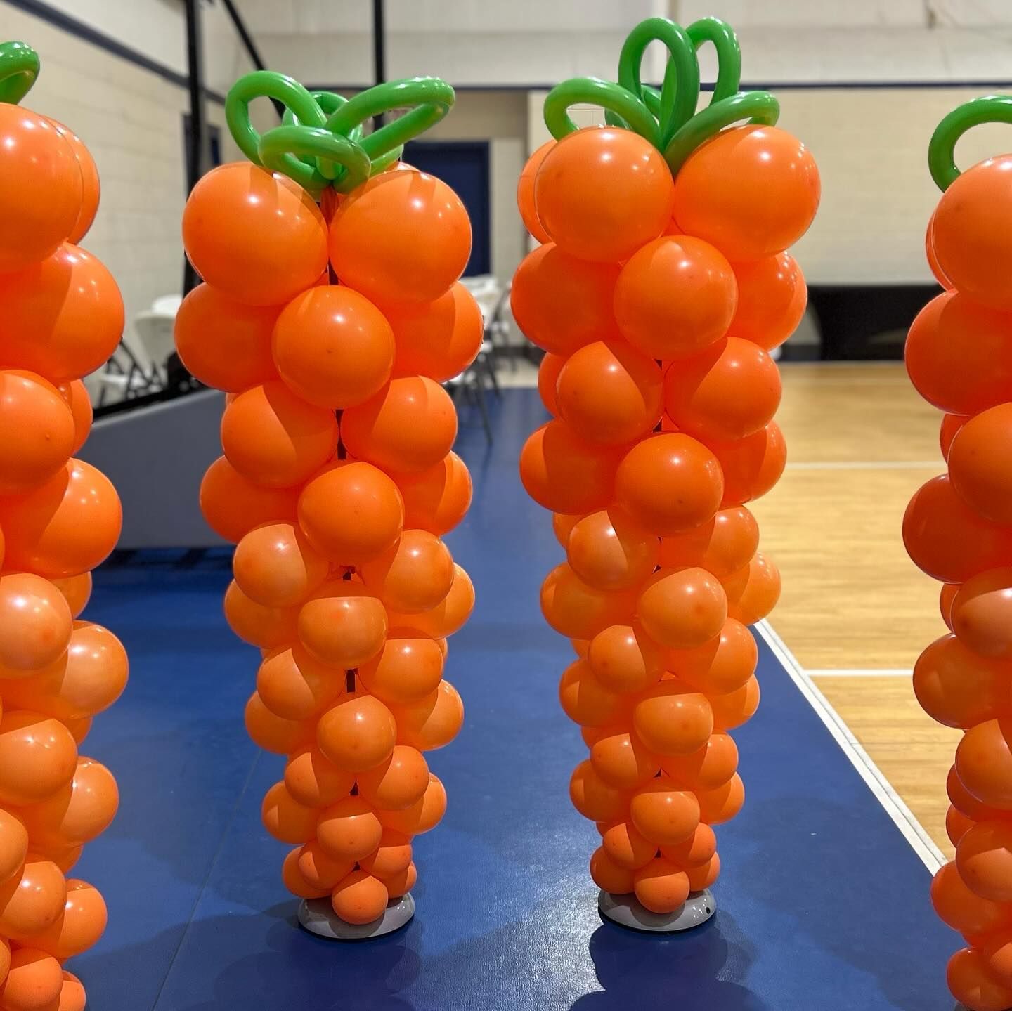 A bunch of orange balloons shaped like carrots