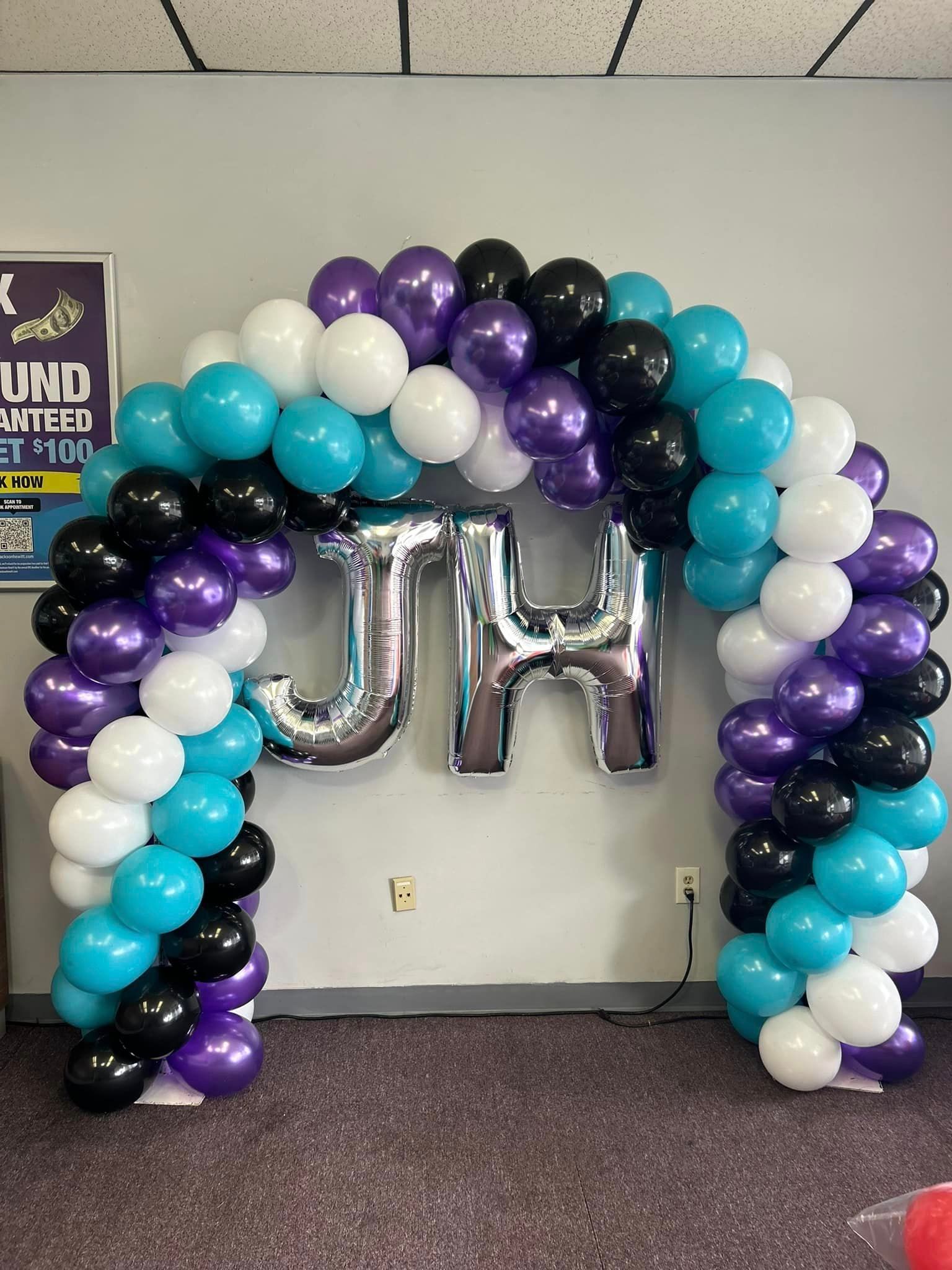 A bunch of balloons are sitting on the floor in a room.