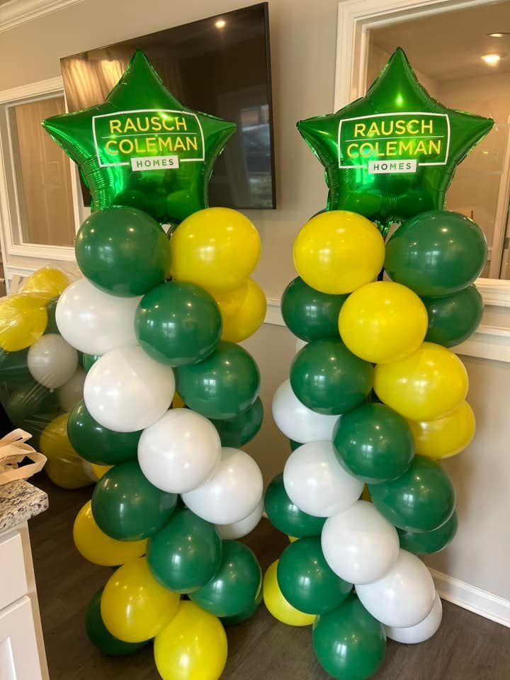 Two columns of green and yellow balloons with rausch coleman balloons
