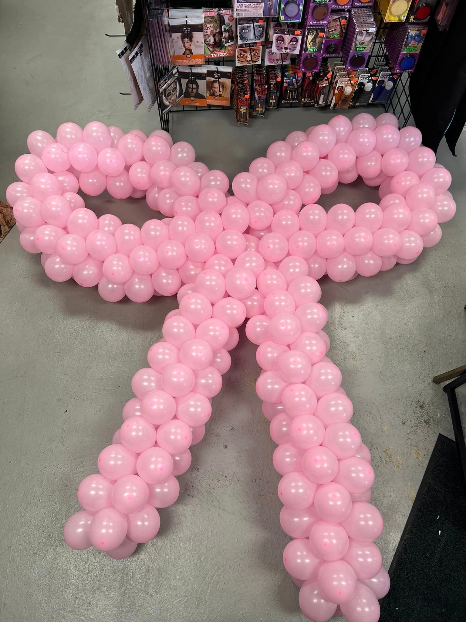 A large pink bow made out of pink balloons