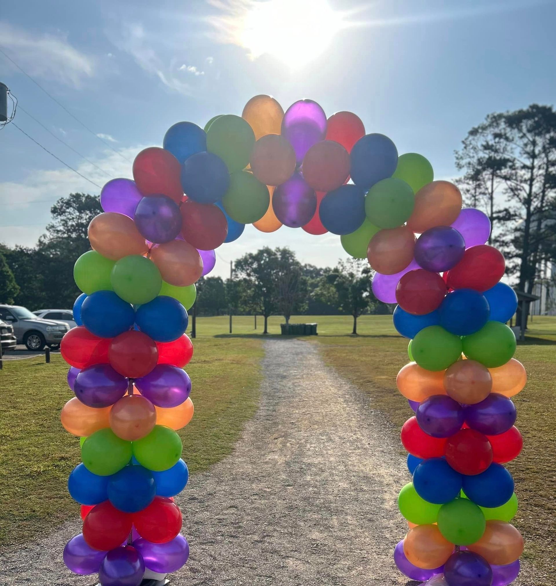 A bunch of colorful balloons are stacked on top of each other