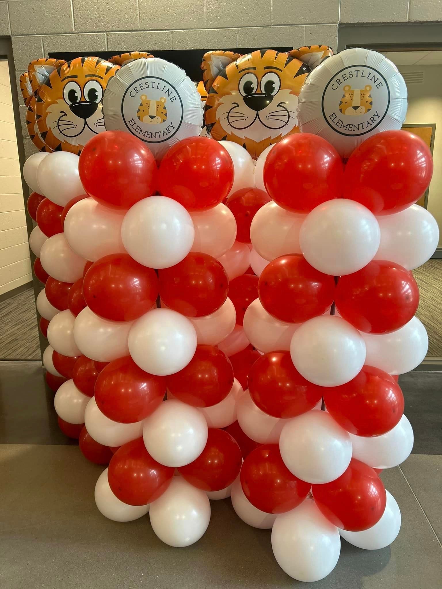 A bunch of red and white balloons are stacked on top of each other