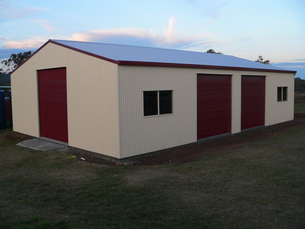 Beige Metal Shed With Red Doors and Trim, Two Windows — Northern Rivers Sheds in South Lismore, NSW
