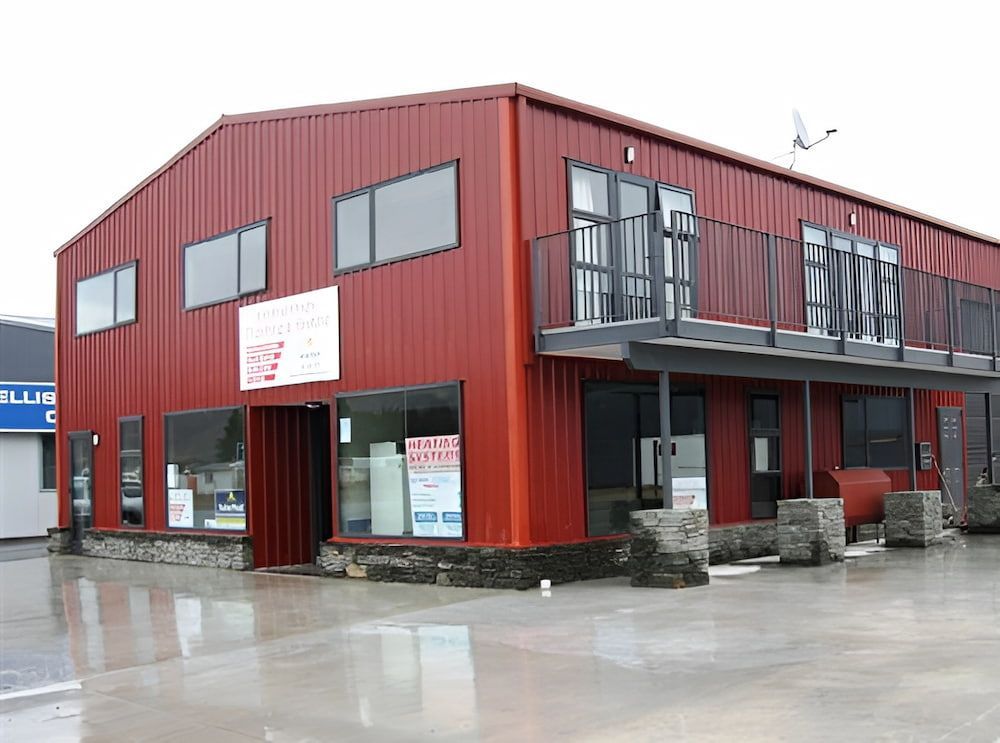 Red Metal Building With Stone Accents; Windows and Balcony; Business Front — Northern Rivers Sheds in South Lismore, NSW