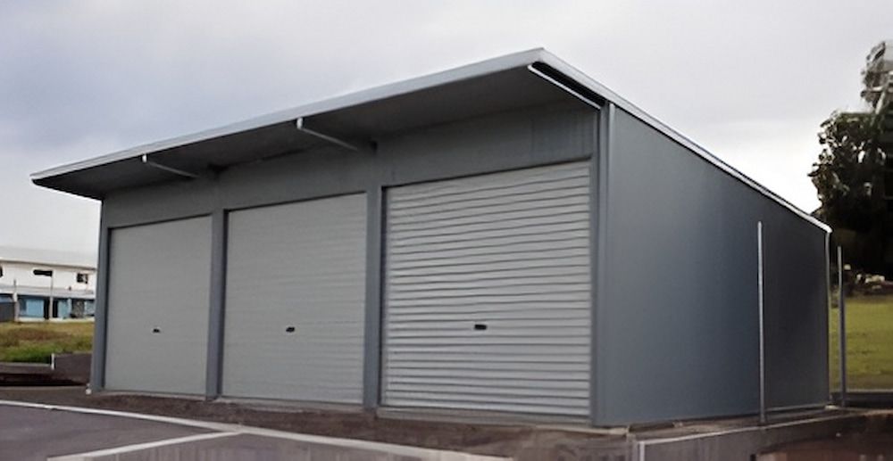 Gray Metal Three-bay Garage With Roll-up Doors — Northern Rivers Sheds in South Lismore, NSW