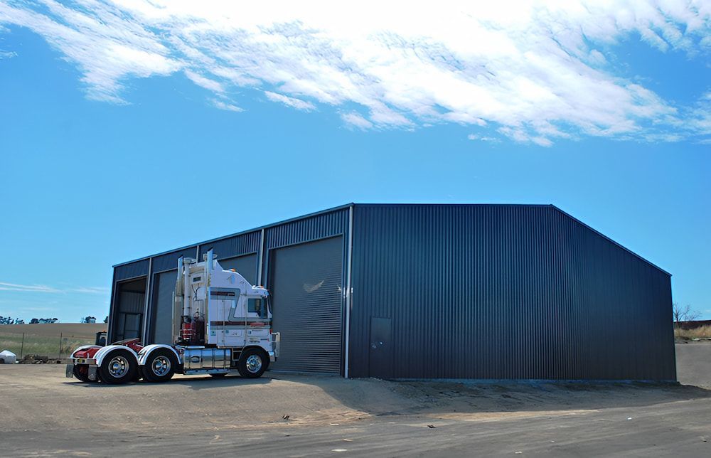 Semi-truck Entering a Large Dark Metal Storage Building — Northern Rivers Sheds in South Lismore, NSW
