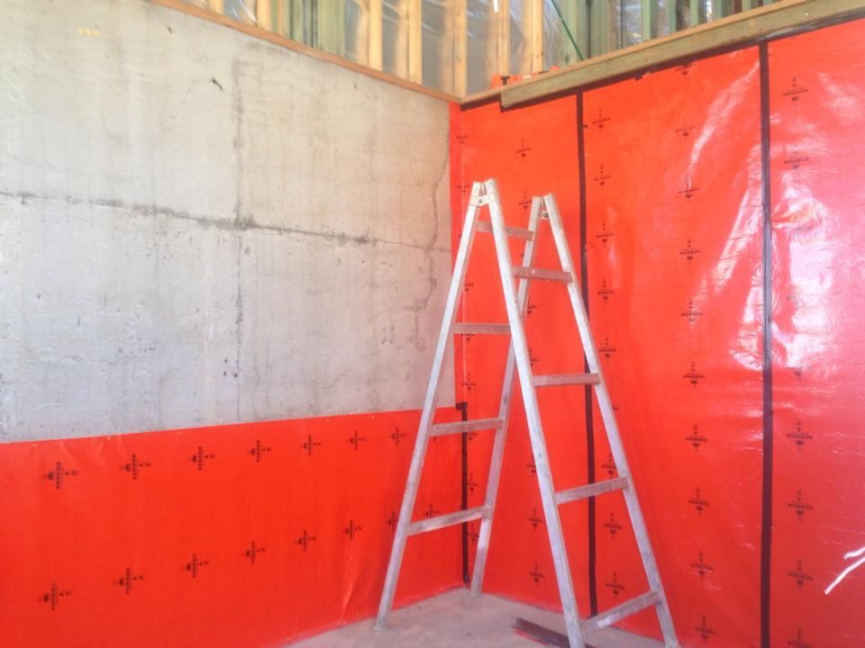 Concrete Wall With Red Moisture Barrier Ladder in Corner — All Pest QLD In Sippy Downs, QLD