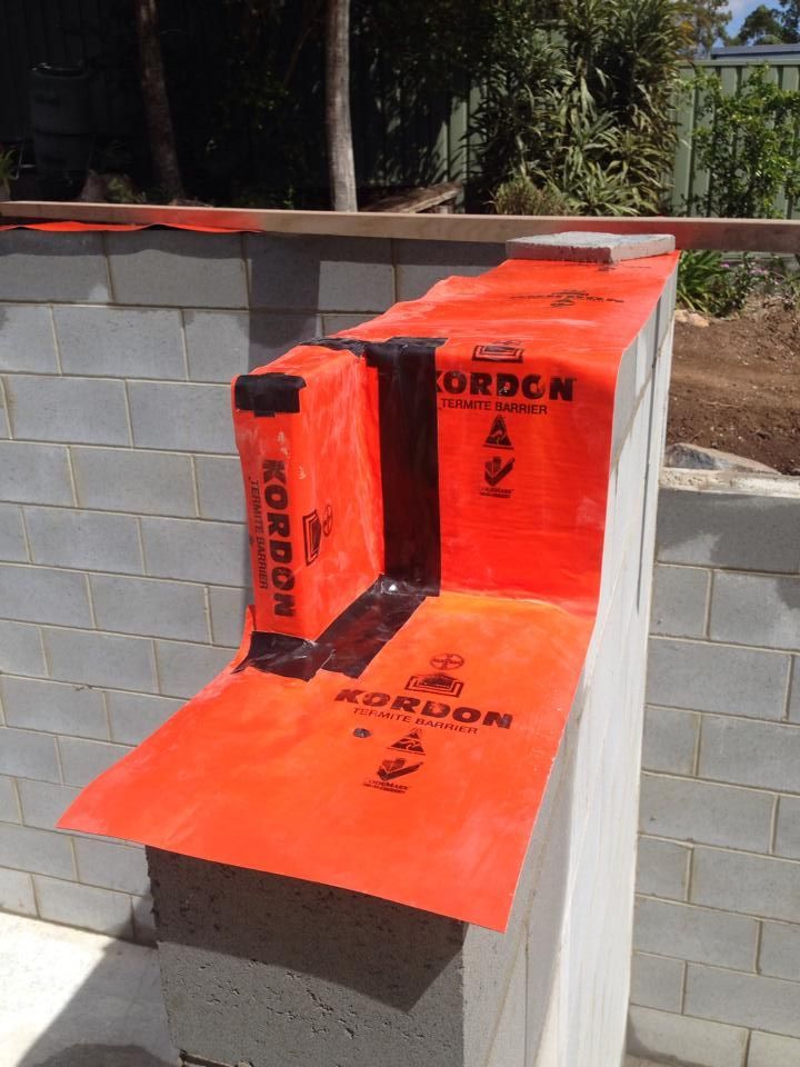 Orange Kordon Termite Barrier Membrane Wrapping a Concrete Block Wall for Waterproofing — All Pest QLD In Sippy Downs, QLD