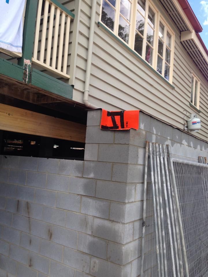 Gray Brick Building With Orange Square — All Pest QLD In Sippy Downs, QLD