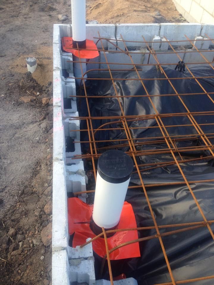 Construction Site With Concrete Blocks Rebar Plastic Sheeting and White Pipes — All Pest QLD In Sippy Downs, QLD