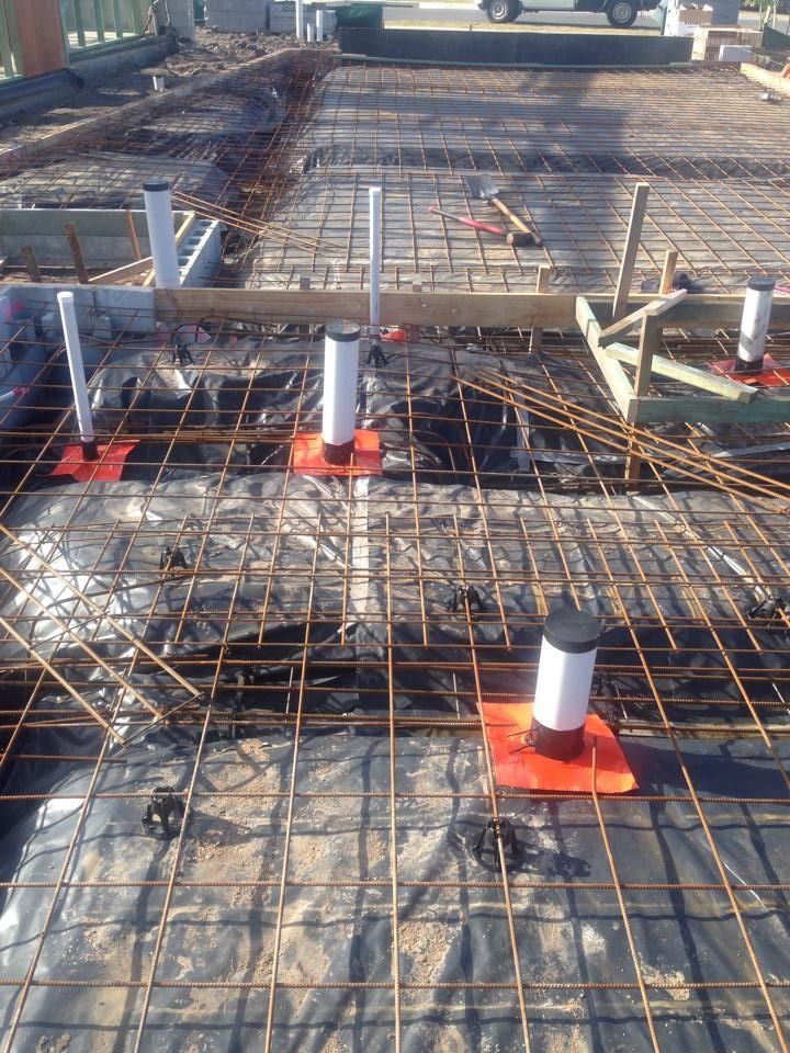 Construction Site With Rebar Grid Plastic Pipes and Orange Bases — All Pest QLD In Caloundra, QLD