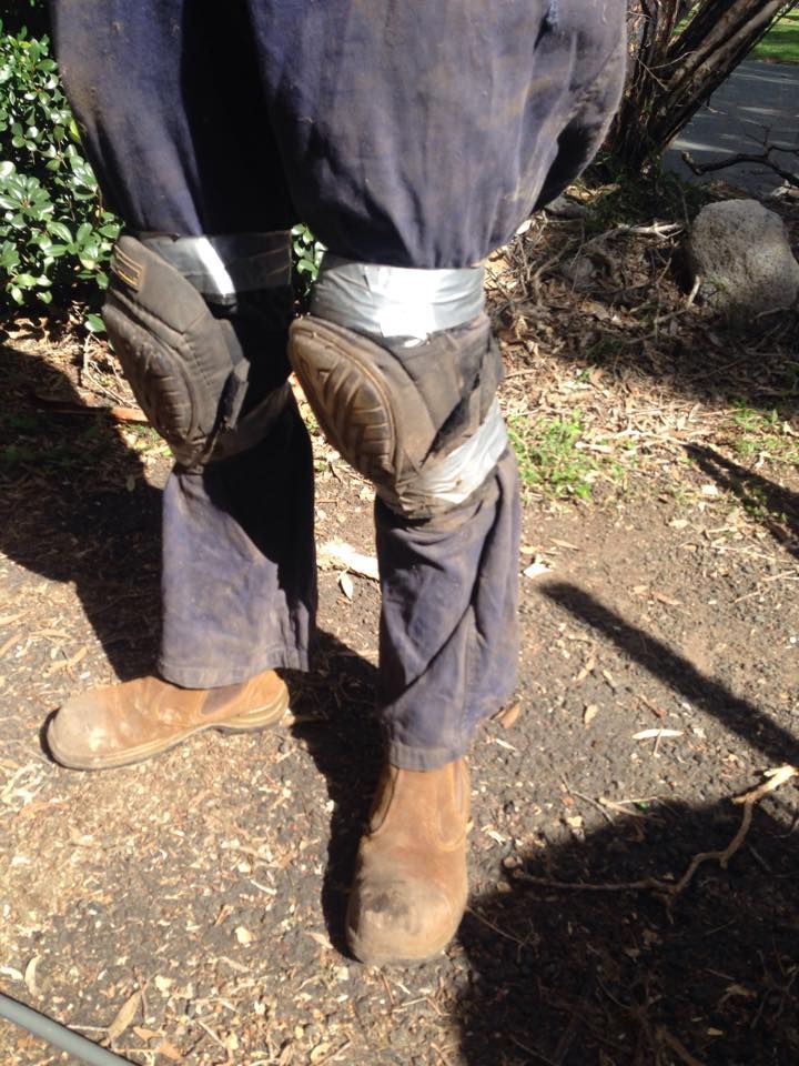 Worker With Blue Pants Brown Boots and Knee Pads Taped on Standing Outdoors — All Pest QLD In Sippy Downs, QLD