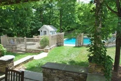 A view of a backyard with a pool and a shed.