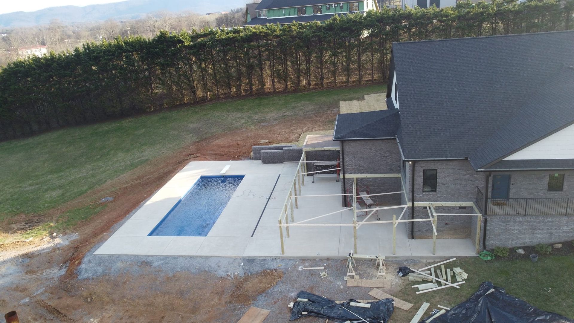 An aerial view of a house with a pool in the backyard.