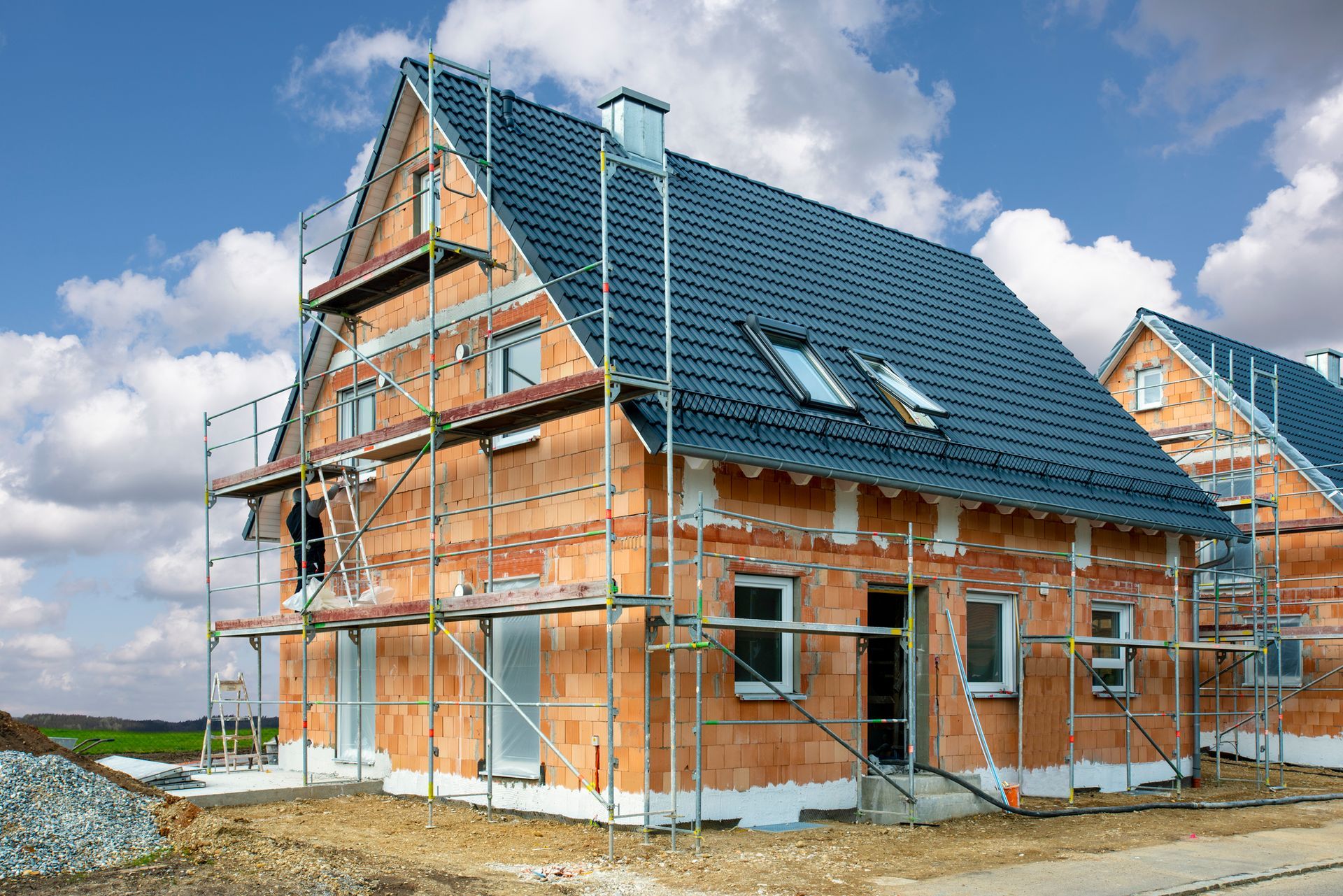 A brick house is being built with scaffolding around it.