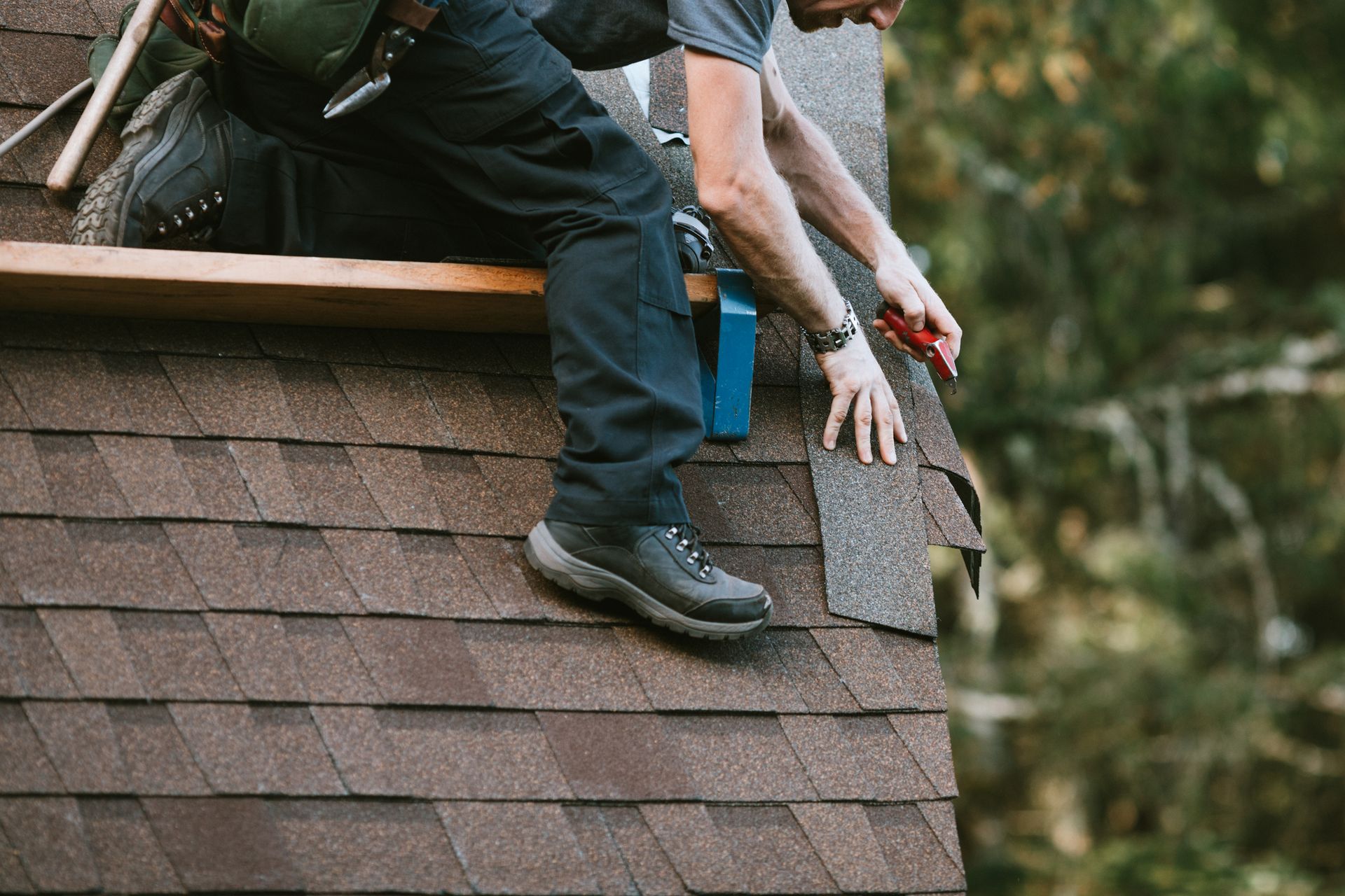A man is working on the roof of a house.