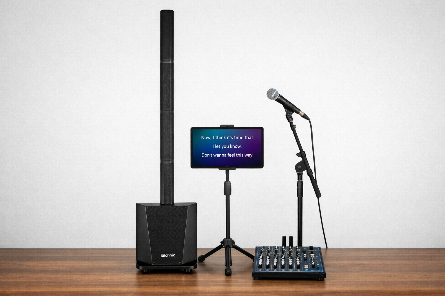 Black PA system with column speaker, microphone, and stand.