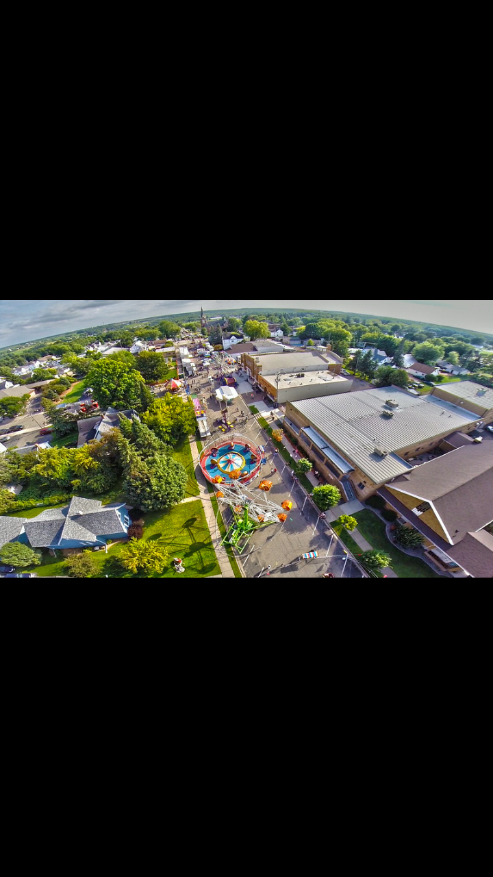 An aerial view of a city with a carnival in the middle of it.