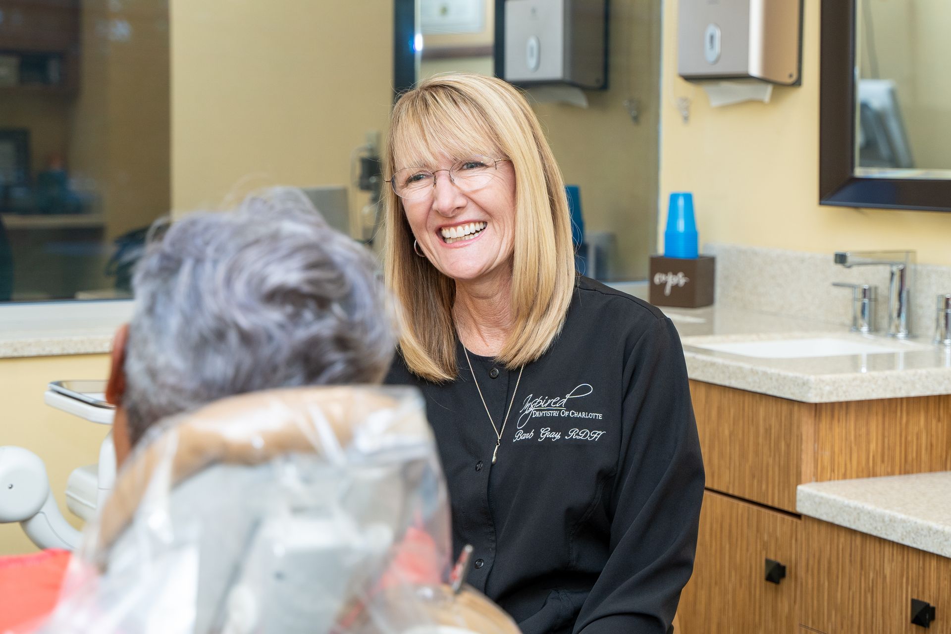 Woman being counseled by dentist about dentures