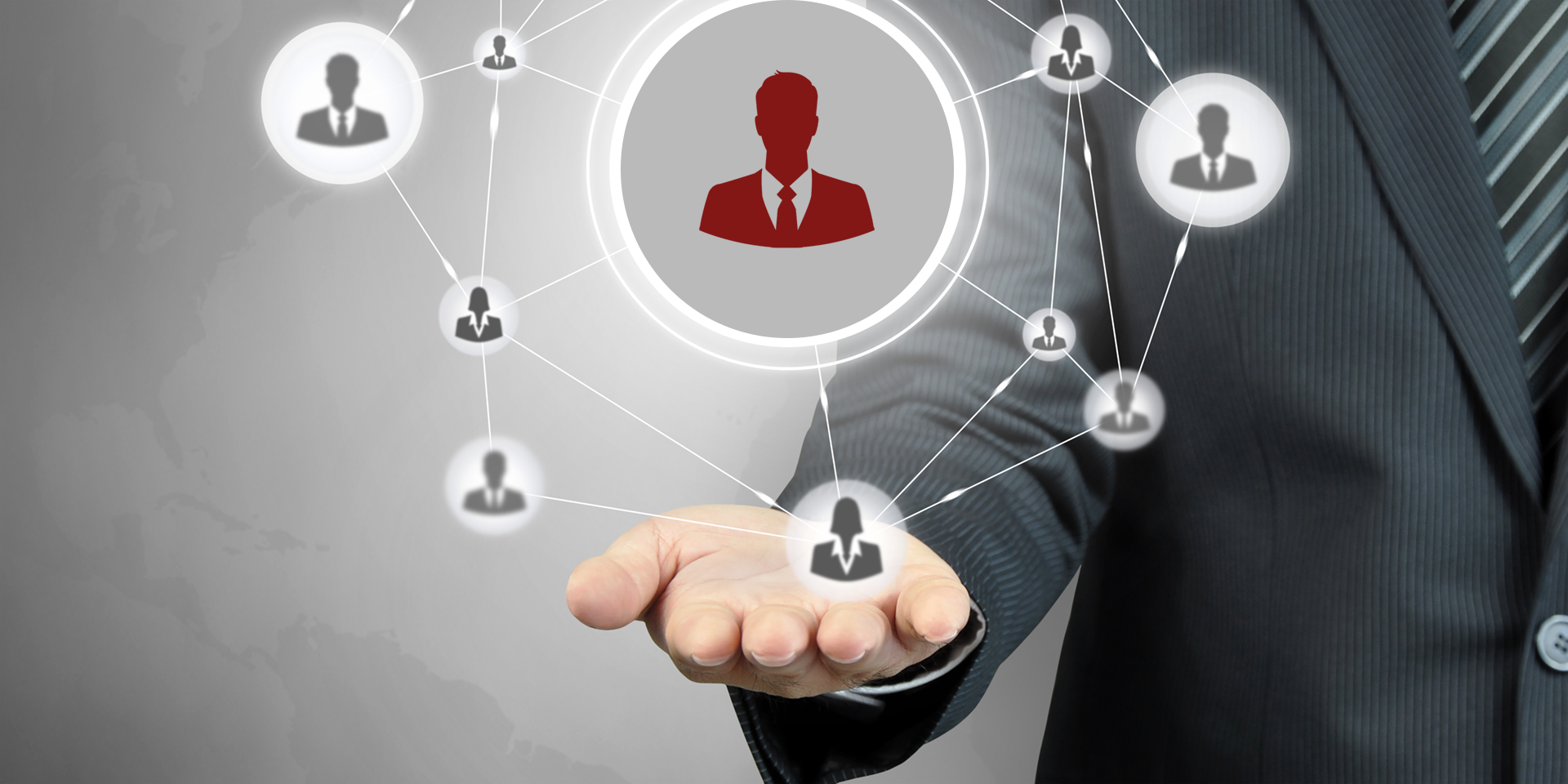 A business professional holding a glowing digital network of interconnected people icons in their open hand.