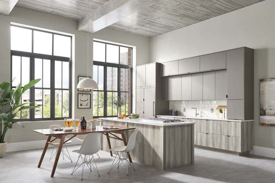 A kitchen with a table and chairs and a large island.