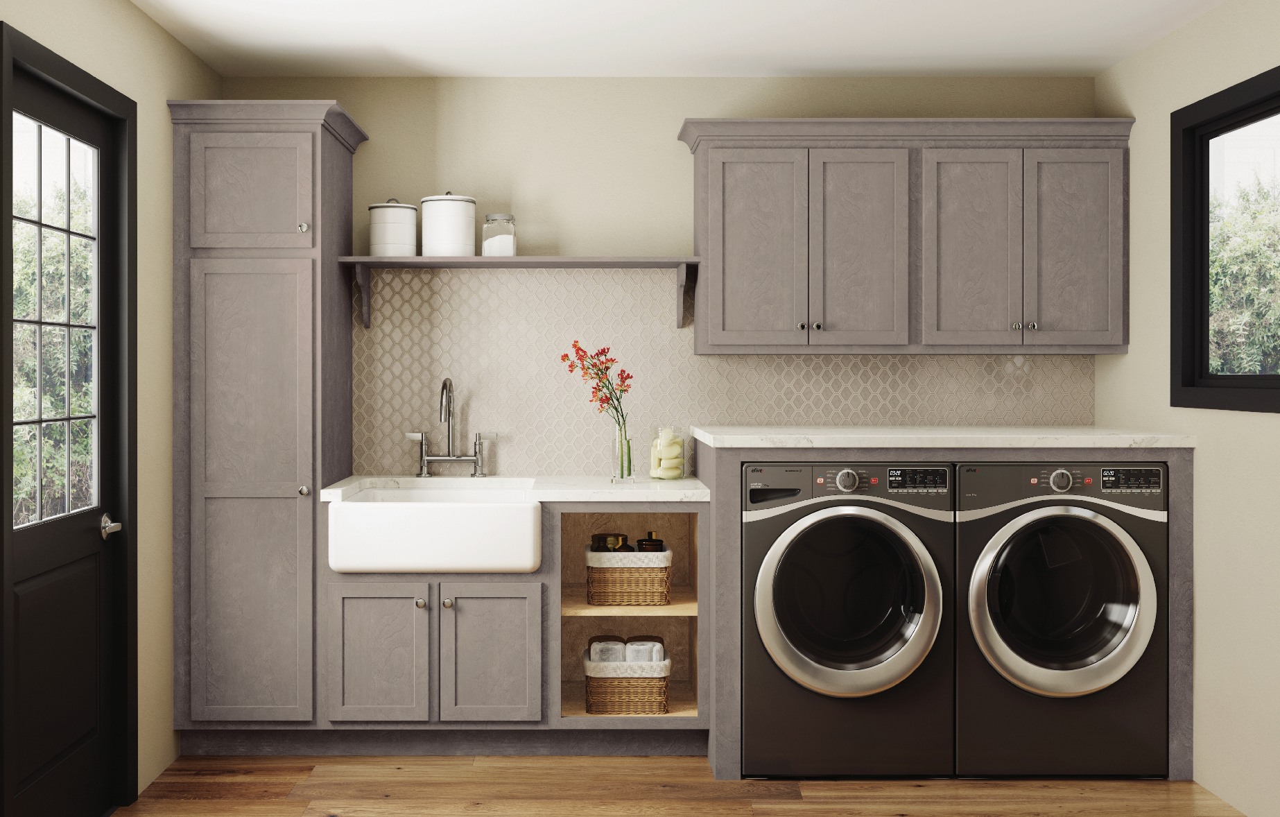A laundry room with two washers and two dryers and a sink.
