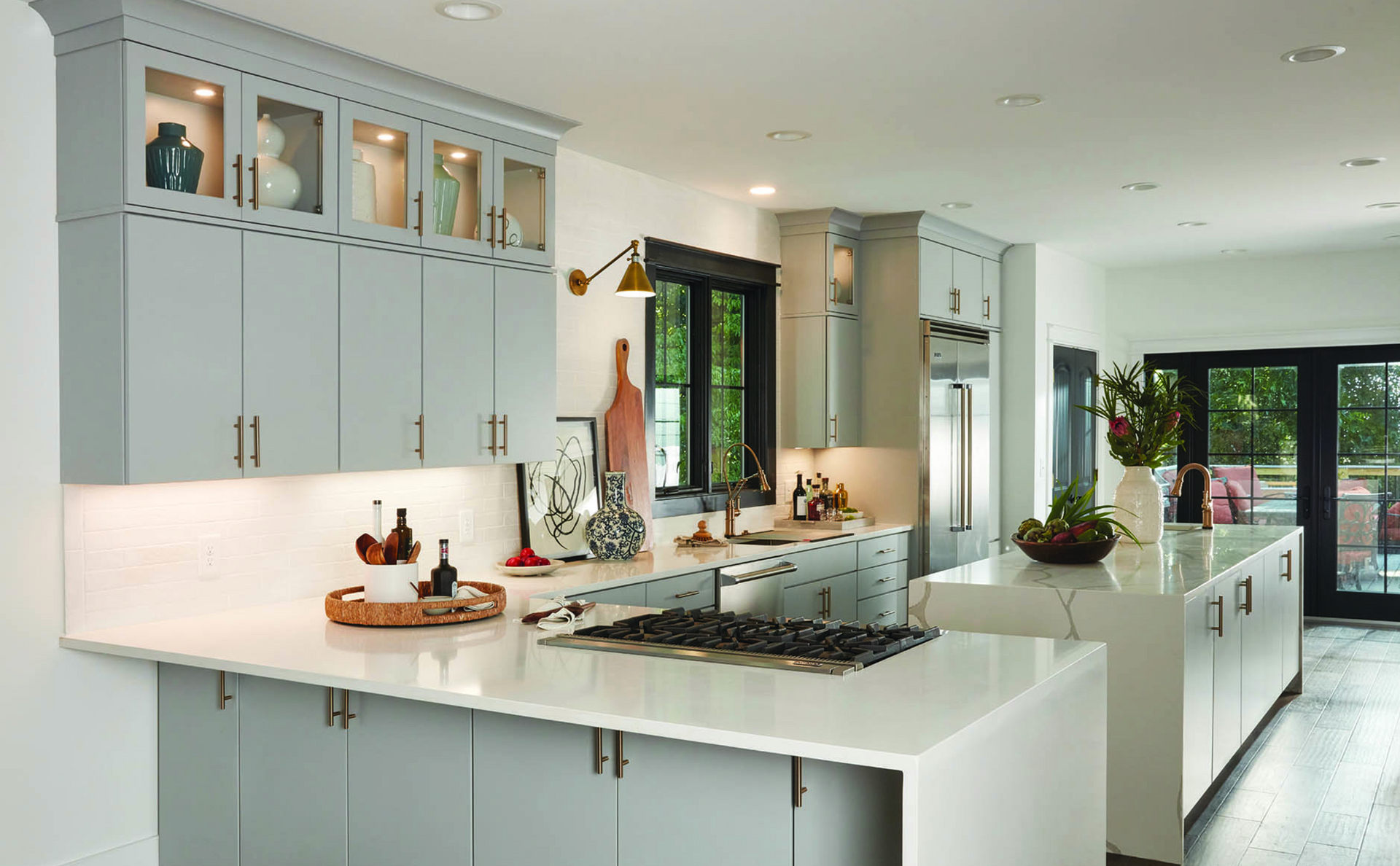 A kitchen with white cabinets and a stove top oven.