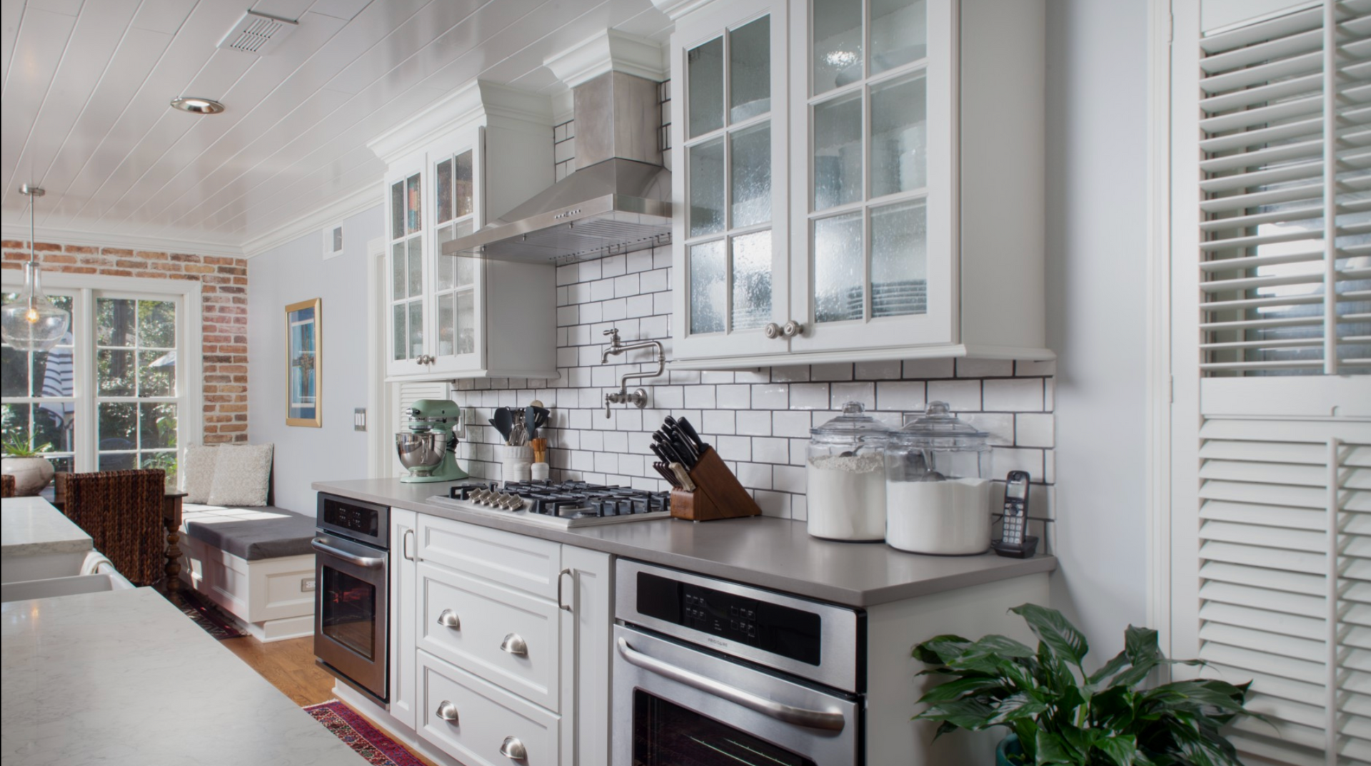 A kitchen with white cabinets and stainless steel appliances.