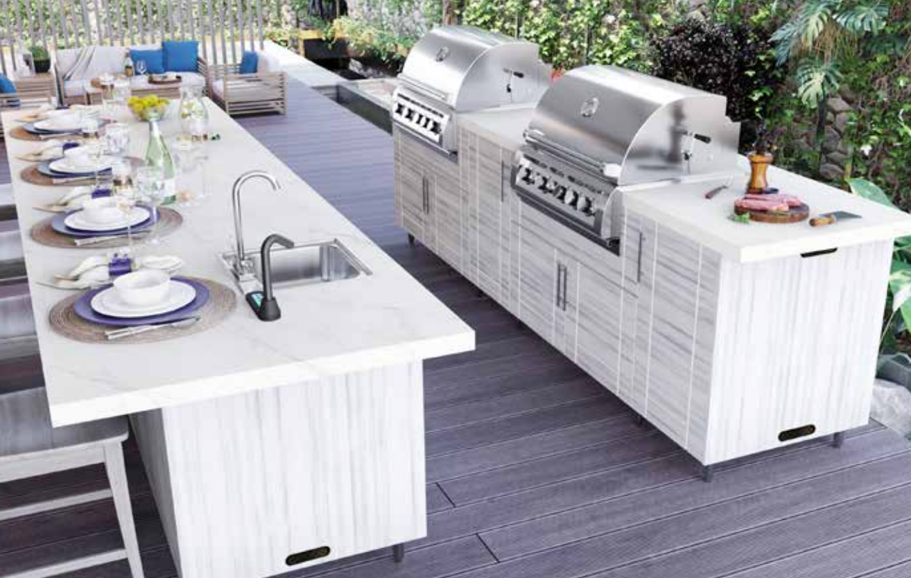 A large outdoor kitchen with a table and chairs and a grill.