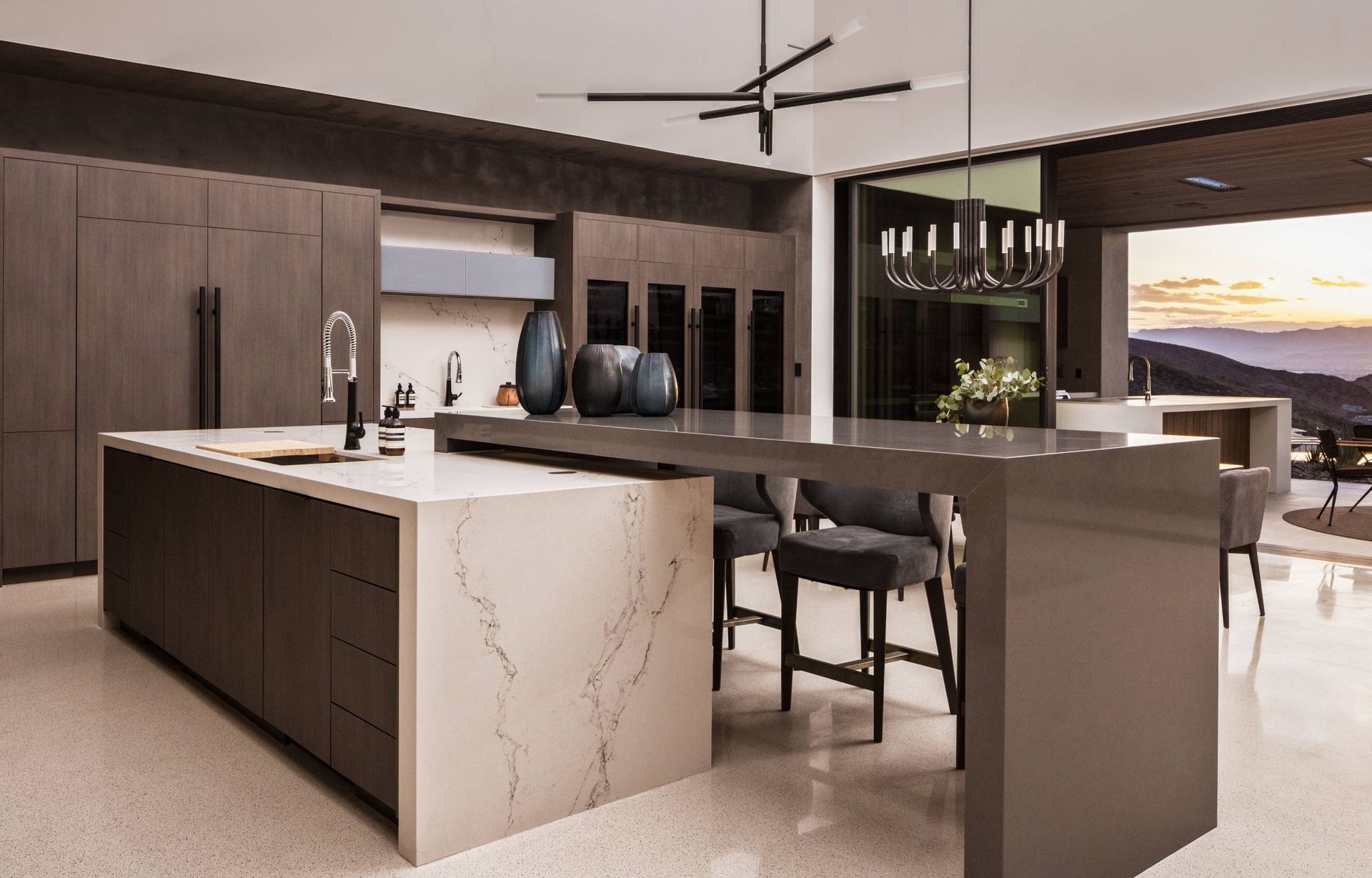 A kitchen with a large island and a ceiling fan