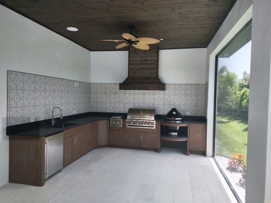 A kitchen with a grill and a ceiling fan