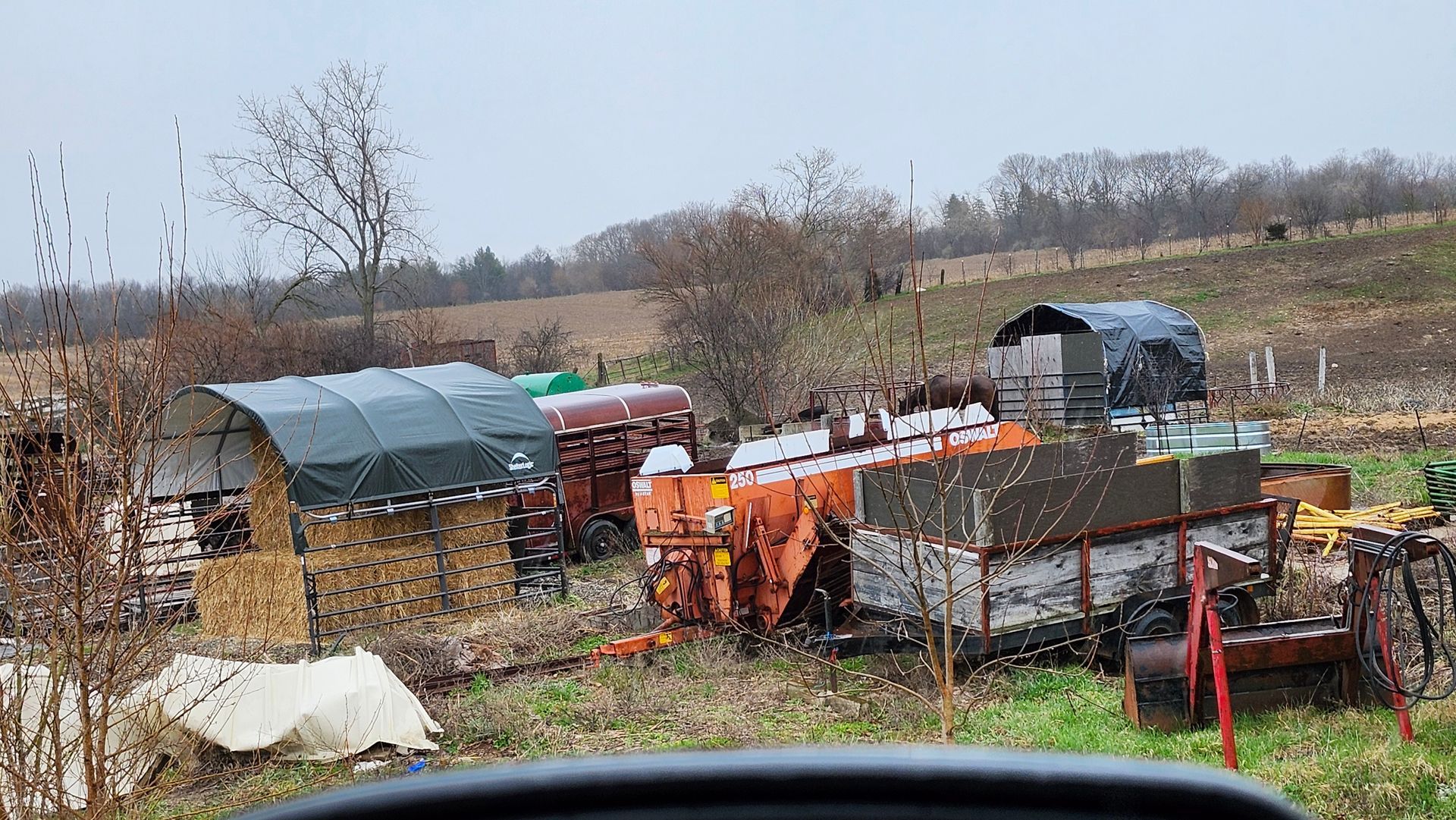 A bunch of old tractors are parked in a field.