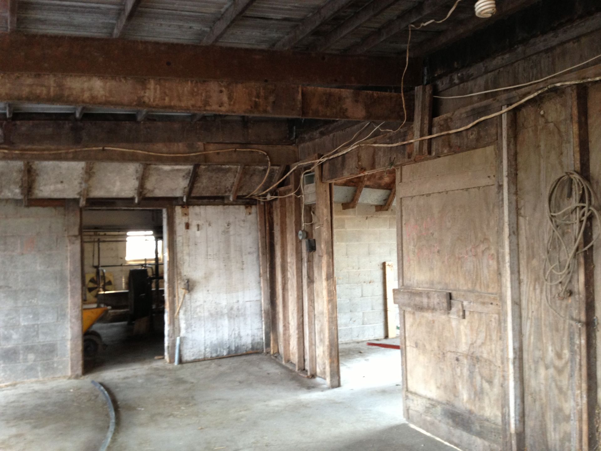A room with wooden walls and a concrete floor.