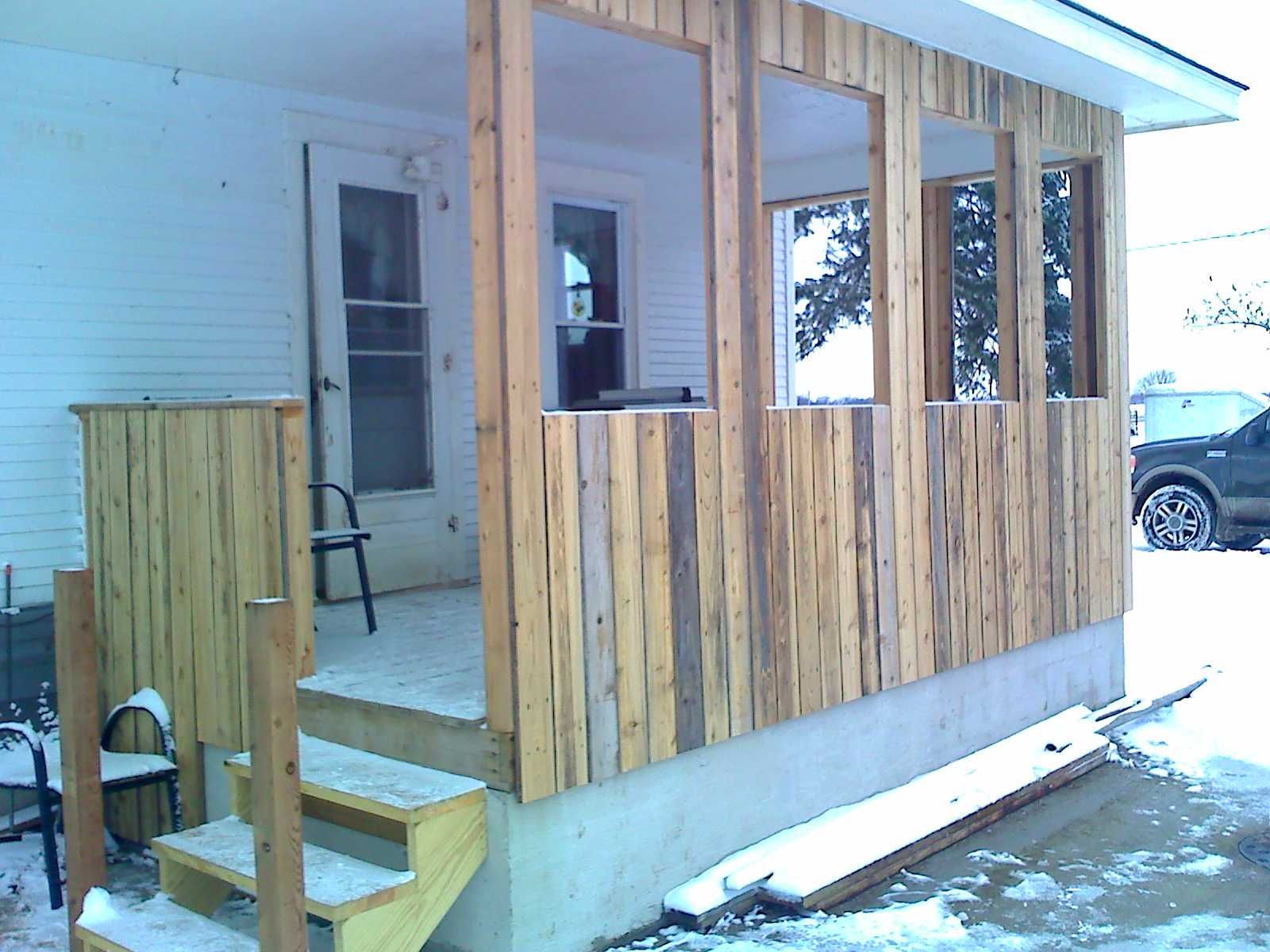 A wooden porch with stairs leading up to it