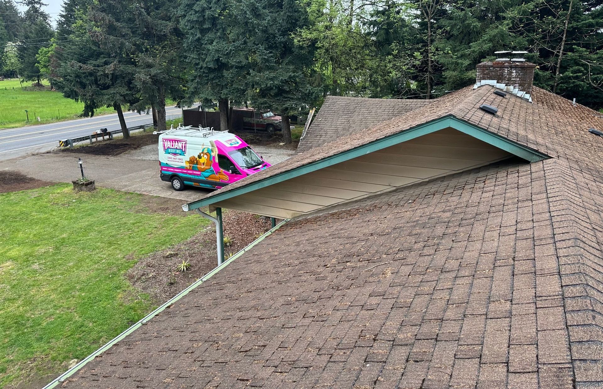 man installing asphalt shingles on a roof