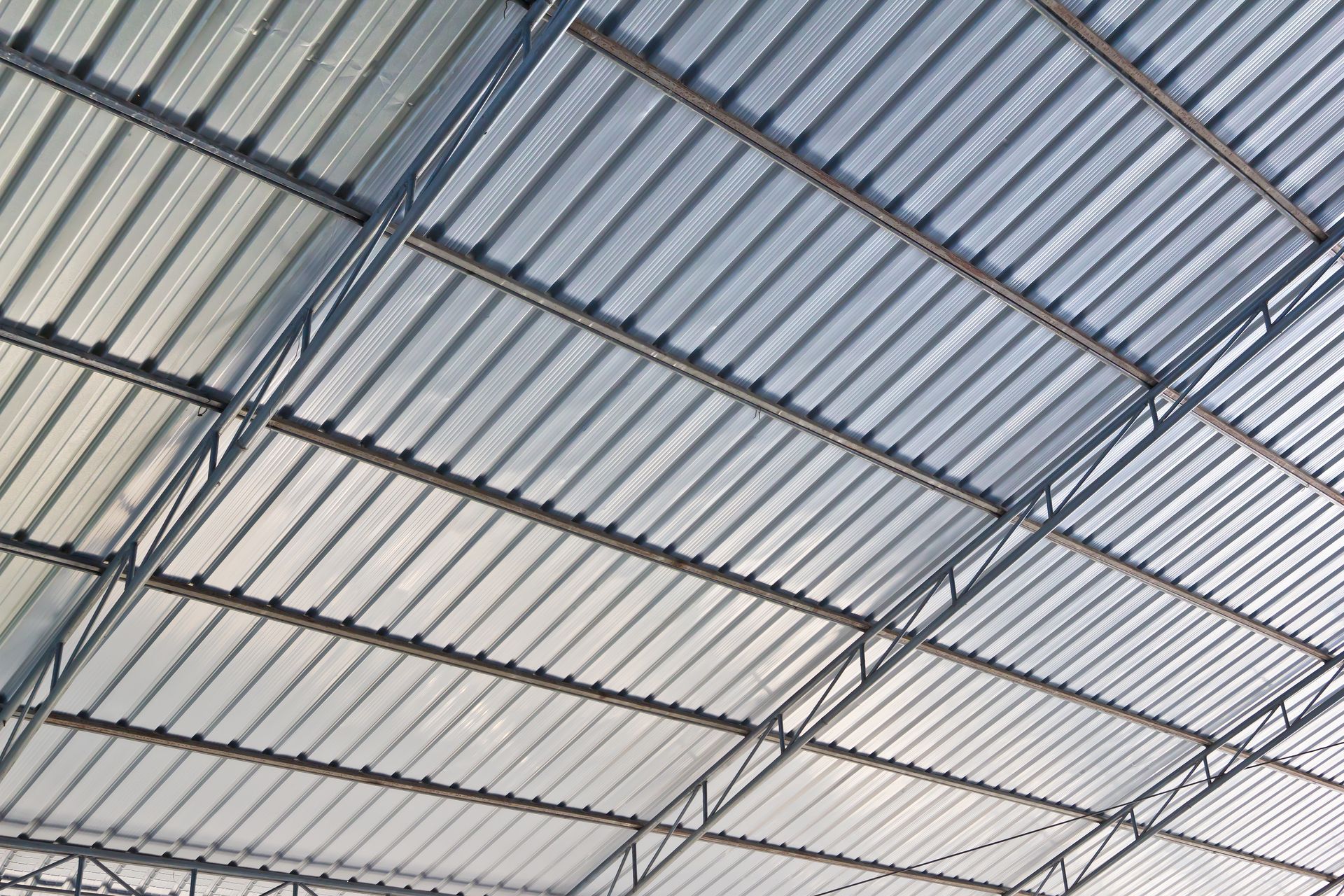 A metal roof of a building with a blue sky in the background.