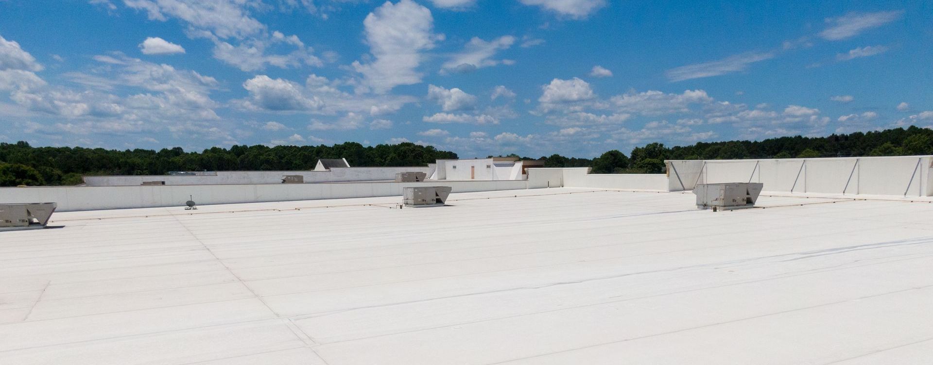 A large white roof with a blue sky in the background.